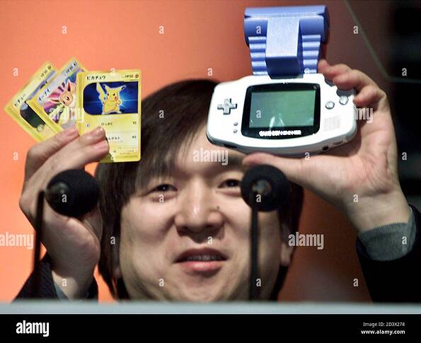 pokemon-or-pocket-monster-producer-tsunekazu-ishihara-flashes-card-e-pokemon-electronic-data-cards-and-their-game-machine